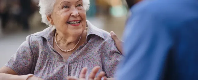 Senior caregiver assisting an older adult during short-term stay respite care