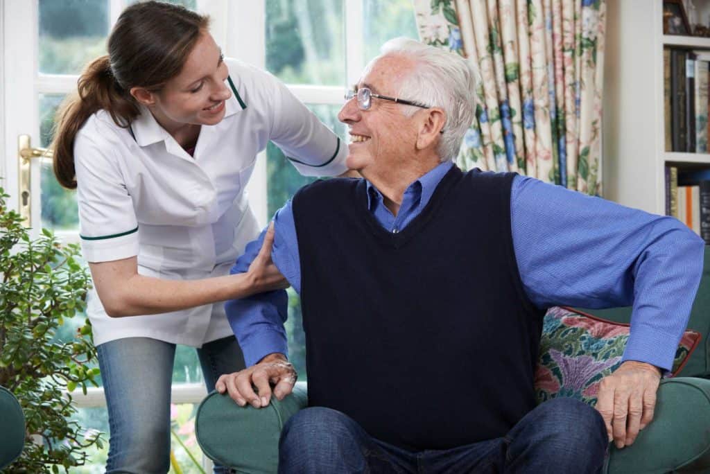 Caregiver Assisting an Old Man